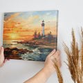 Framed canvas print of a lighthouse overlooking the ocean at sunset with vibrant sky and calm water reflections