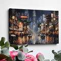 Framed canvas print of an urban street scene with illuminated pagoda and glistening rain-covered streets at night