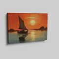 Framed canvas print of a sailboat against an orange sunset with water reflections