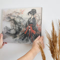 Framed canvas print of a geisha in a traditional black and red attire, set against an Asian-inspired misty mountainous landscape with ink wash and watercolour.