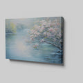 Framed canvas print of serene riverscape with cherry blossoms in impressionist style