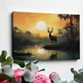 Framed canvas print of a majestic stag against a forest lake at sunrise with orange skies